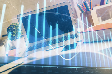Financial chart drawing and table with computer on background. Double exposure. Concept of international markets.