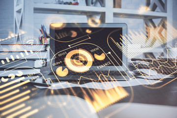 Computer on desktop in office with technology theme hologram. Multi exposure. Tech concept.