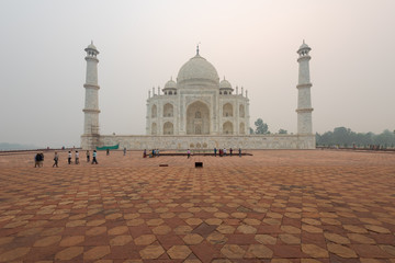 Left side of the Taj Mahal in Agra, India, on overcast morning with smog