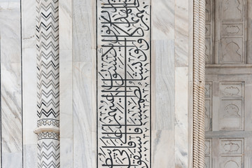 Detail of architectural decoration made of white marble, black onyx and other stones on the Taj Mahal in Agra, India