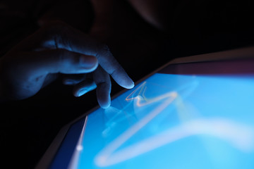 Close up of man hand analyzing stock chart on digital tablet 