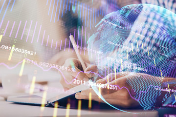 Multi exposure of two men planing investment with stock market forex chart.