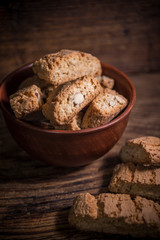 Cantucci cookies with almonds on rustic wooden background