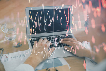 Multi exposure of market chart with man working on computer on background. Concept of financial analysis.