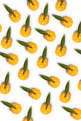 Top view on bright fresh and aromatic orange Mandarins, tangerine with green leaves on white background. Flat lay, a lot of yellow-orange mandarins look very delicious