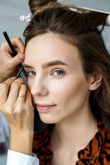 Happy young woman came for makeup in a professional beauty salon. Female portrait
