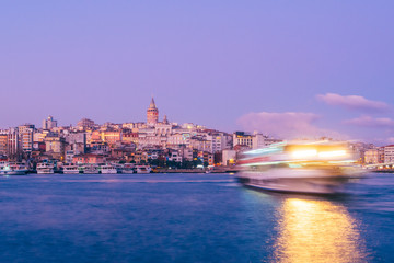 Fototapeta na wymiar Istanbul, Turkey - Jan 15, 2020: Galata Tower with Ferry Boat in Golden Horn , Istanbul, Turkey,