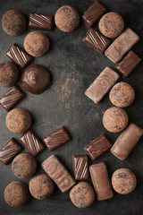 Assorted chocolate candies on dark background