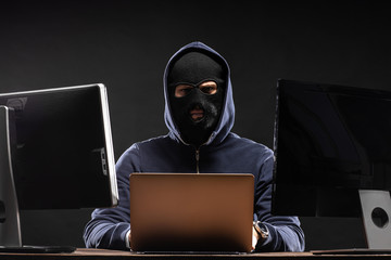 young dangerous hacker bandit engaged in crime, don't afraid of strangers, entered the room and...