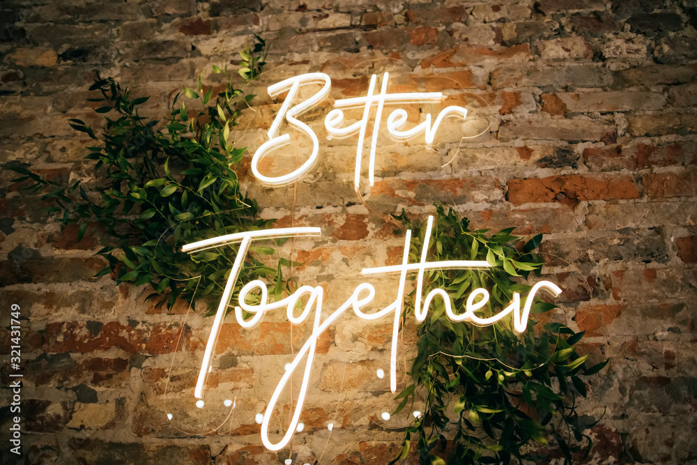 Wall mural Better Together - neon sign on a brick wall in a restaurant at a wedding party. Love concept