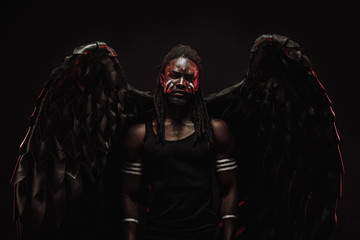 tormented african angel with black wings, angel has strong muscular body and dreadlocks on head....