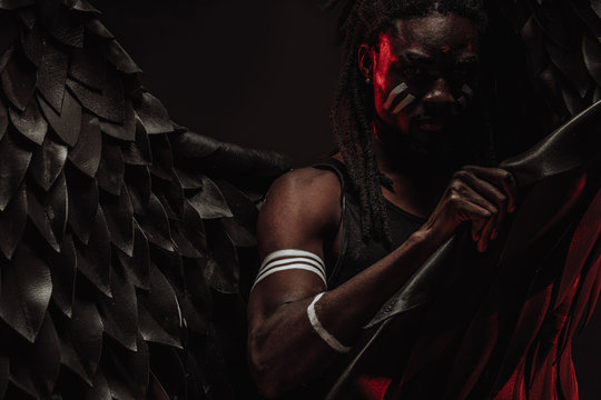 portrait of black african angel, gothic dark angel for peace in the human world, angel suppresses a demon within every living being. isolated photoshoot