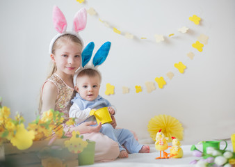 Cute little children boy and girl wearing bunny ears in Easter decor
