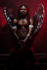 young muscular man in the flesh of angel stand confidently looking at camera, having magnificent...