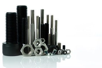 Metal bolts and nuts on white background. Fasteners equipment. Hardware tools. Stud bolt, hex nuts,...