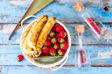 Bananas and strawberries in a basket with aloe vera