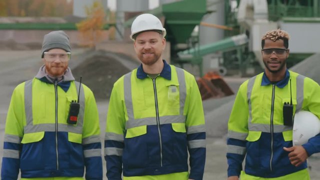 Stone manufacturing worker team with hugging each other standing outside
