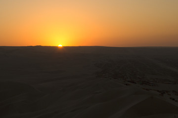 Fototapeta na wymiar Sunset in Huacachina desert, Peru
