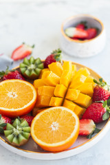Big bowl of mango, oranges, strawberries and kiwi fruit