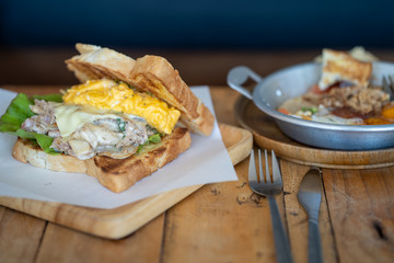 Tuna sandwish on wooden table.