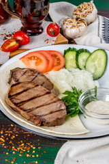 Cooked veal tongue with fresh vegetables. Shot in the decor