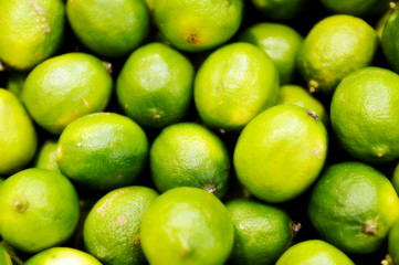 Fresh green lemon lime texture background / pile of lime for sale in the market