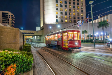 NEW ORLEANS, LA - FEBRUARY 8, 2016: City colourful tram along city streets at night