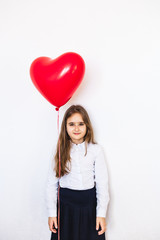 Fototapeta na wymiar European-looking girl on a white background holding a heart-shaped balloon, balloon, heart, love, Valentine's day, birthday, holiday