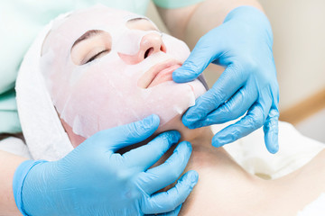 Procedure female cosmetic mask and chistak face in a beauty salon.