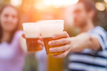 Friends enjoying drinking beer in the backyard.