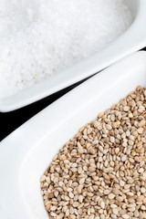 Preparation of gomashio (gomasio - sekihan seasoning ) with sesame seeds and salt in Suribachi (Japanese streak mortar). Top view.