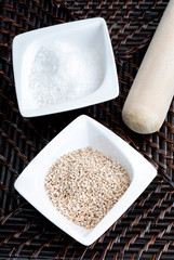 Preparation of gomashio (gomasio - sekihan seasoning ) with sesame seeds and salt in Suribachi (Japanese streak mortar). Top view.