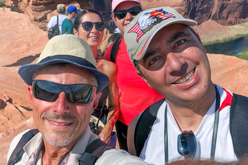 Group of happy tourists visiting national park taking selfies