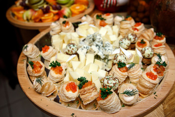 Cheese snacks on a wooden tray.