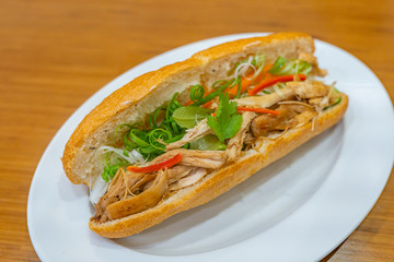 Traditional Vietnamese chicken meat sandwich and scallion- Banh Mi
