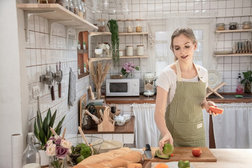 Beautiful young woman cooking in kitchen
