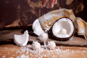 Close up of white candies and coconut with white pulp, coconut chip on wooden background..