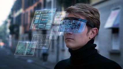 An young man is using futuristic innovative technology vr mask with augmented reality anonymous holograms in a city center. Concept of future,innovation, immersive technology, gaming,virtual reality