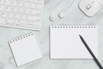 Notepad and office utensils on marble table. Creative flat lay photo of workspace desk with copy space. 