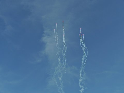 Wide Shot Of Fireworks Shooting Up Into The Blue Skies