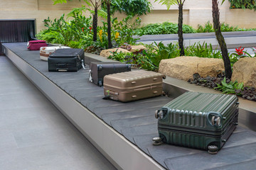 Passenger luggage on conveyor belt at arrival terminal in airport 