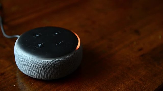 FLORENCE, ITALY-01/25/2020-Closeup of caucasian man hands set up Amazon Echo Dot