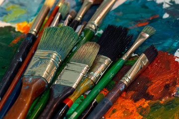 Fototapeta premium Colorful paint brushes. Art concept. Painting process.