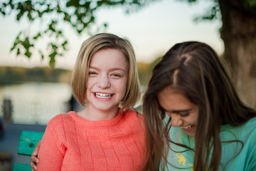 Two smiling girls. Two friends. Happy female students having fun together. Two young girls in the evening outside 