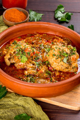 Georgian dish chakhokhbili in a clay plate. Shot in the decor