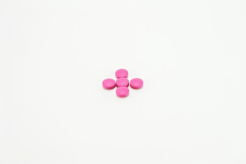 pink pills on a white background