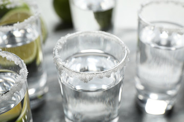 Mexican Tequila shots with salt on table, closeup
