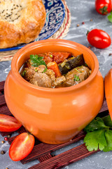 Soup in a pot with meat and vegetables. Shot in the decor