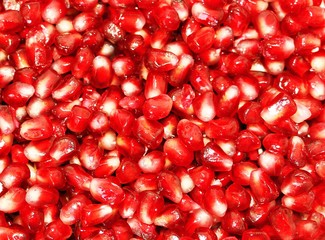 Red background from ripe fresh pomegranate seeds