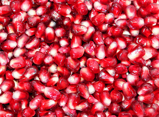 Red background from ripe fresh pomegranate seeds